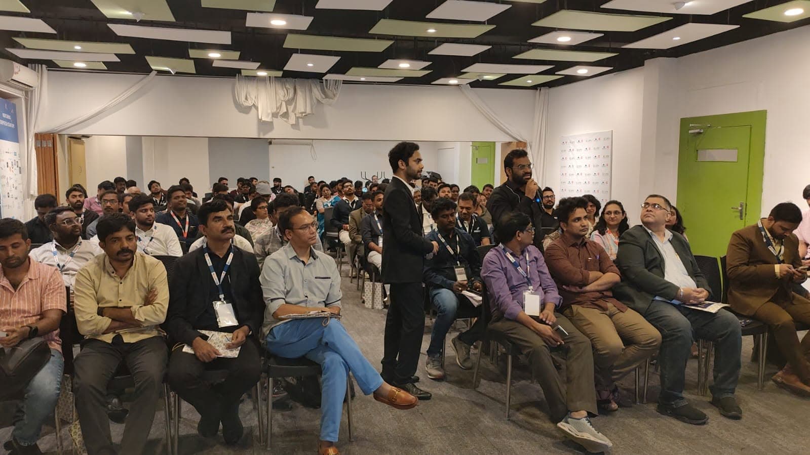 Conference attendees listening to a panel discussion